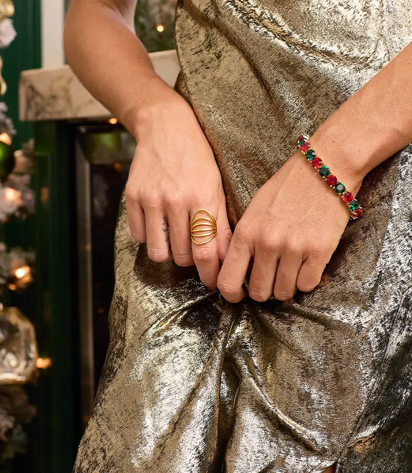Model holding her hand up to her face wearing a gold and bronze ring