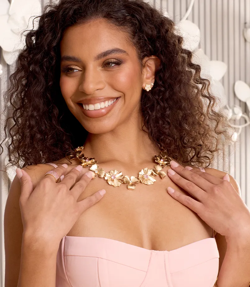 Model wearing a bold gold necklace