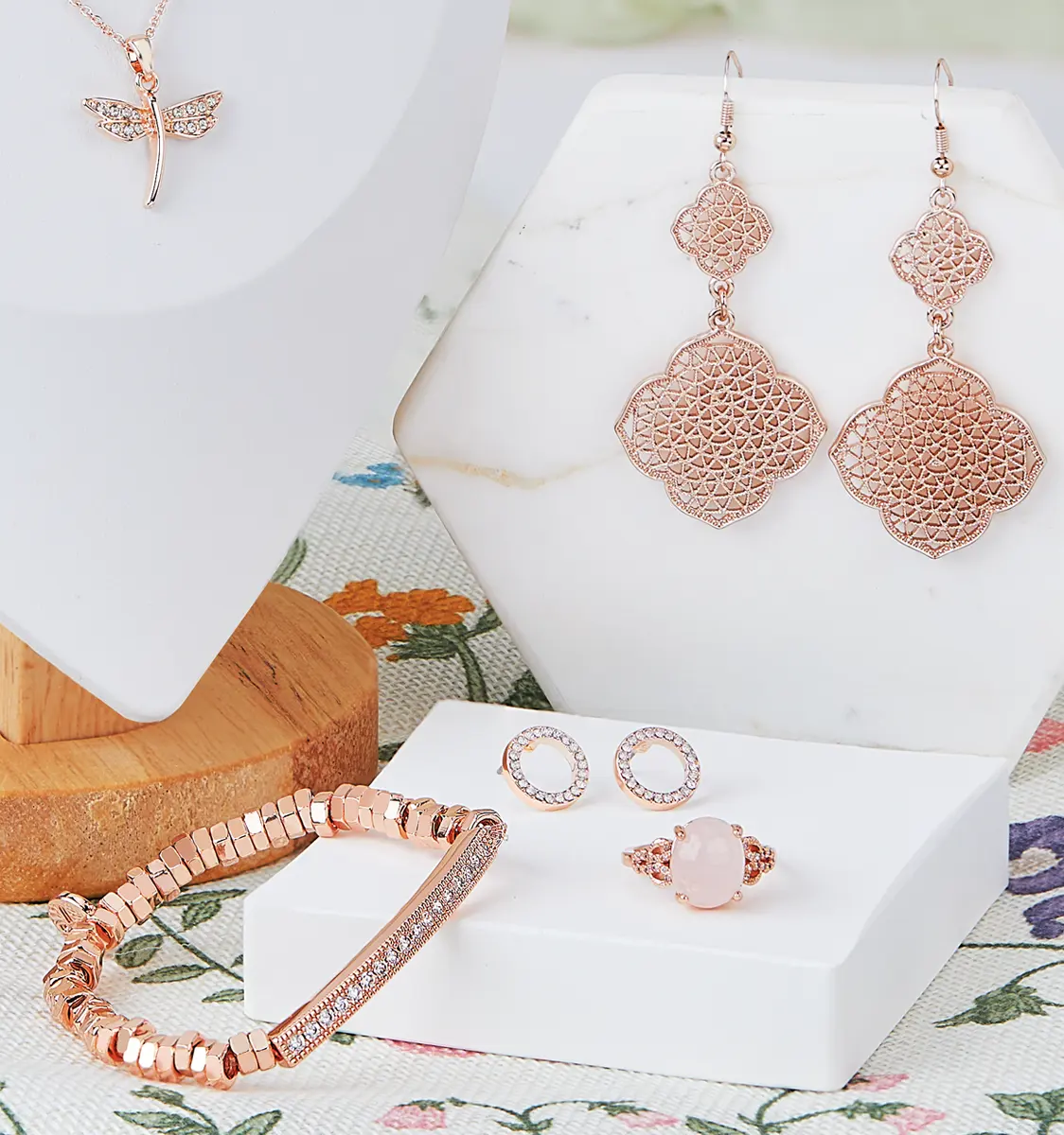 Model in green dress wearing Gold hoop earrings looking to her left